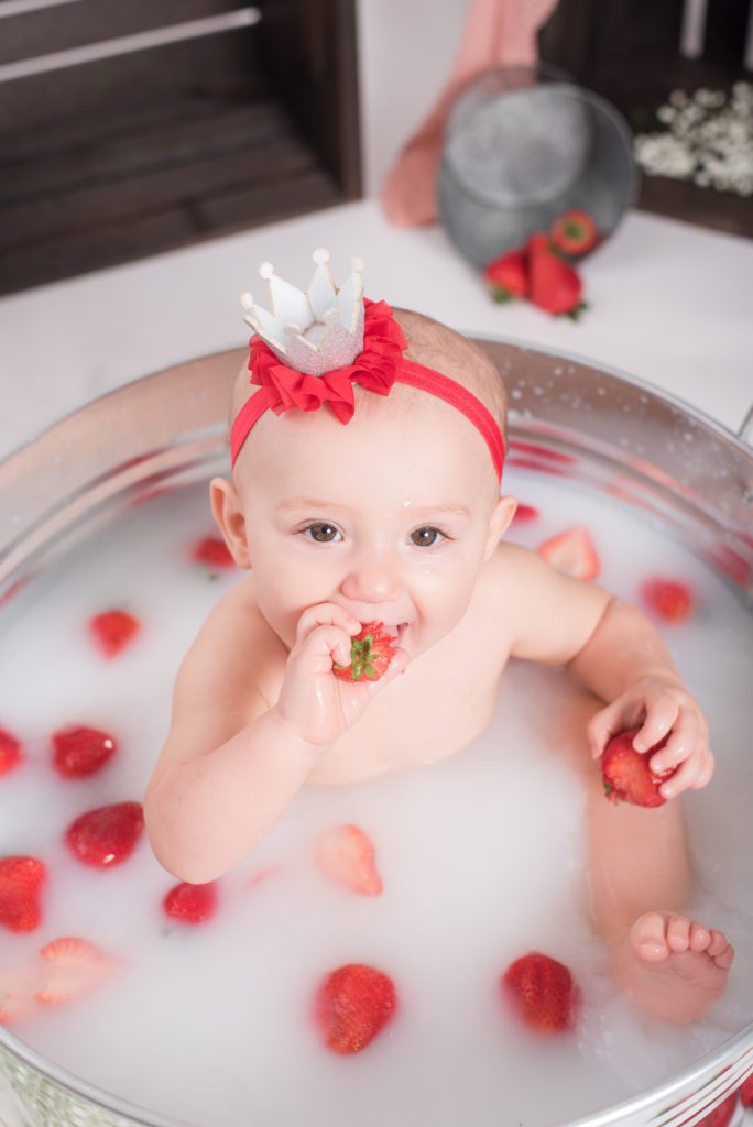 Taking a strawberry bath after Annessa's first year cake smash