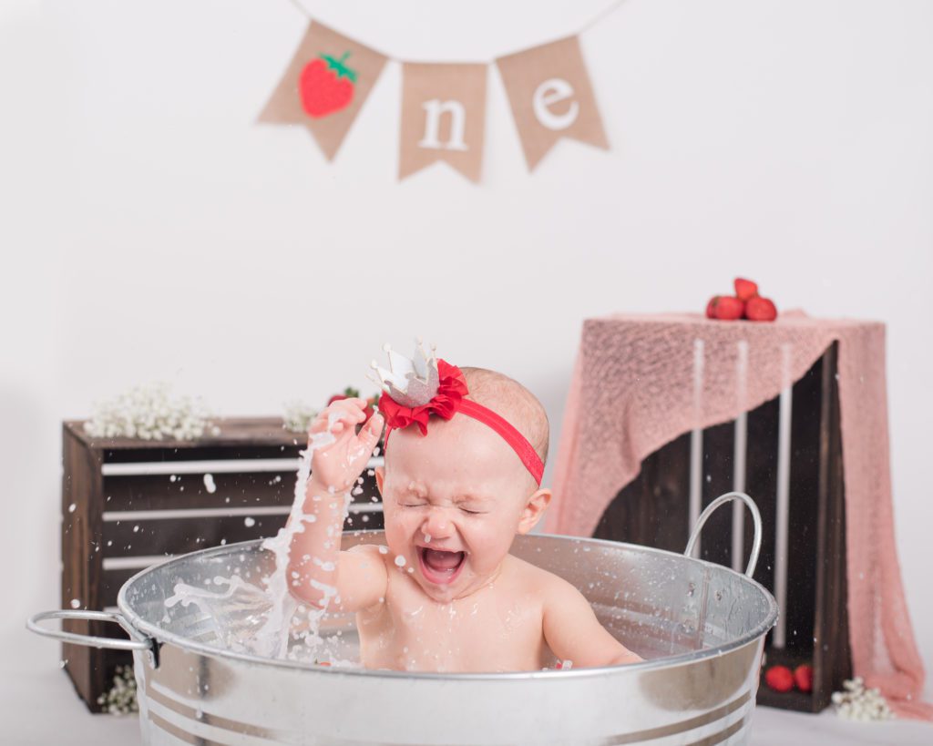 Taking a strawberry bath after Annessa's first year cake smash