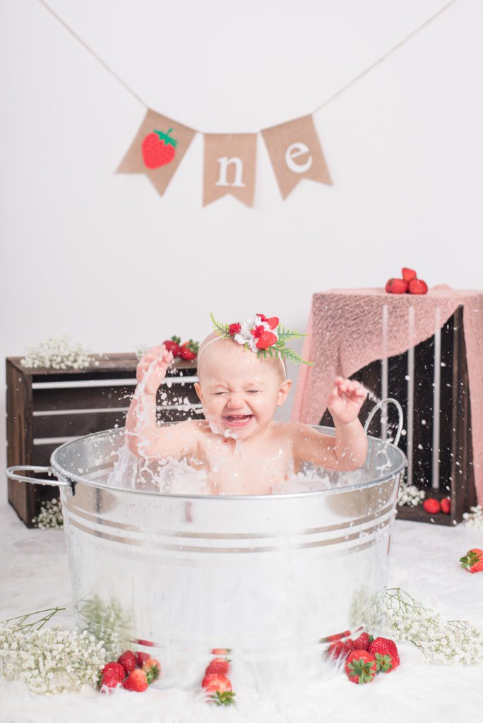 Taking a strawberry bath after Annessa's first year cake smash