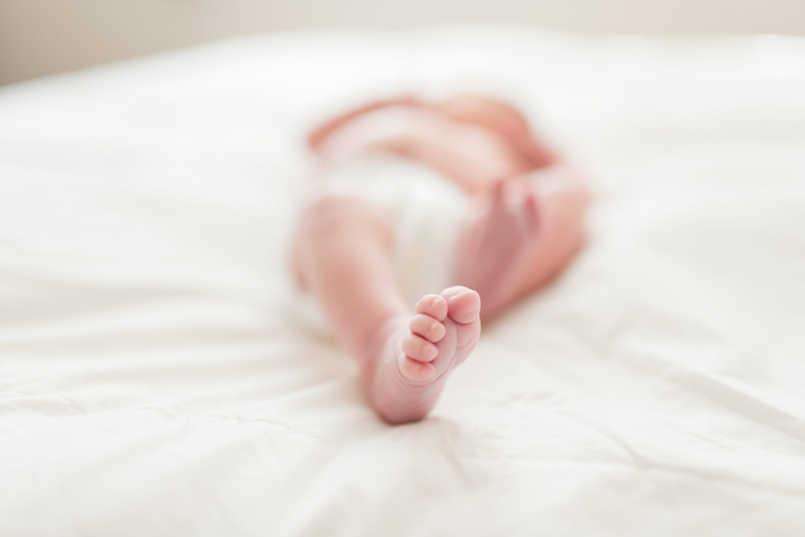 Annessa as a newborn sleeping on the bed