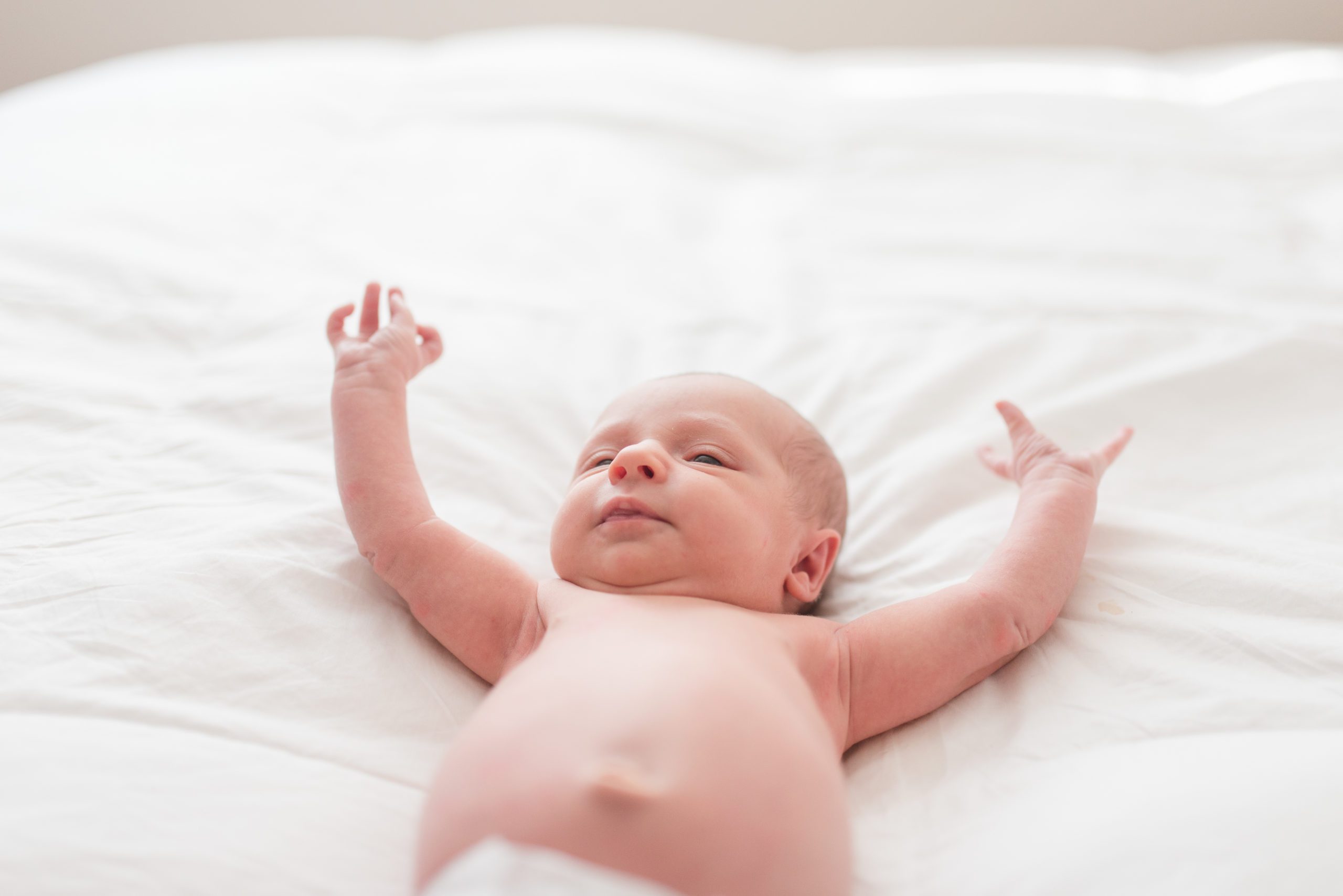 Annessa stretching on bed as newborn