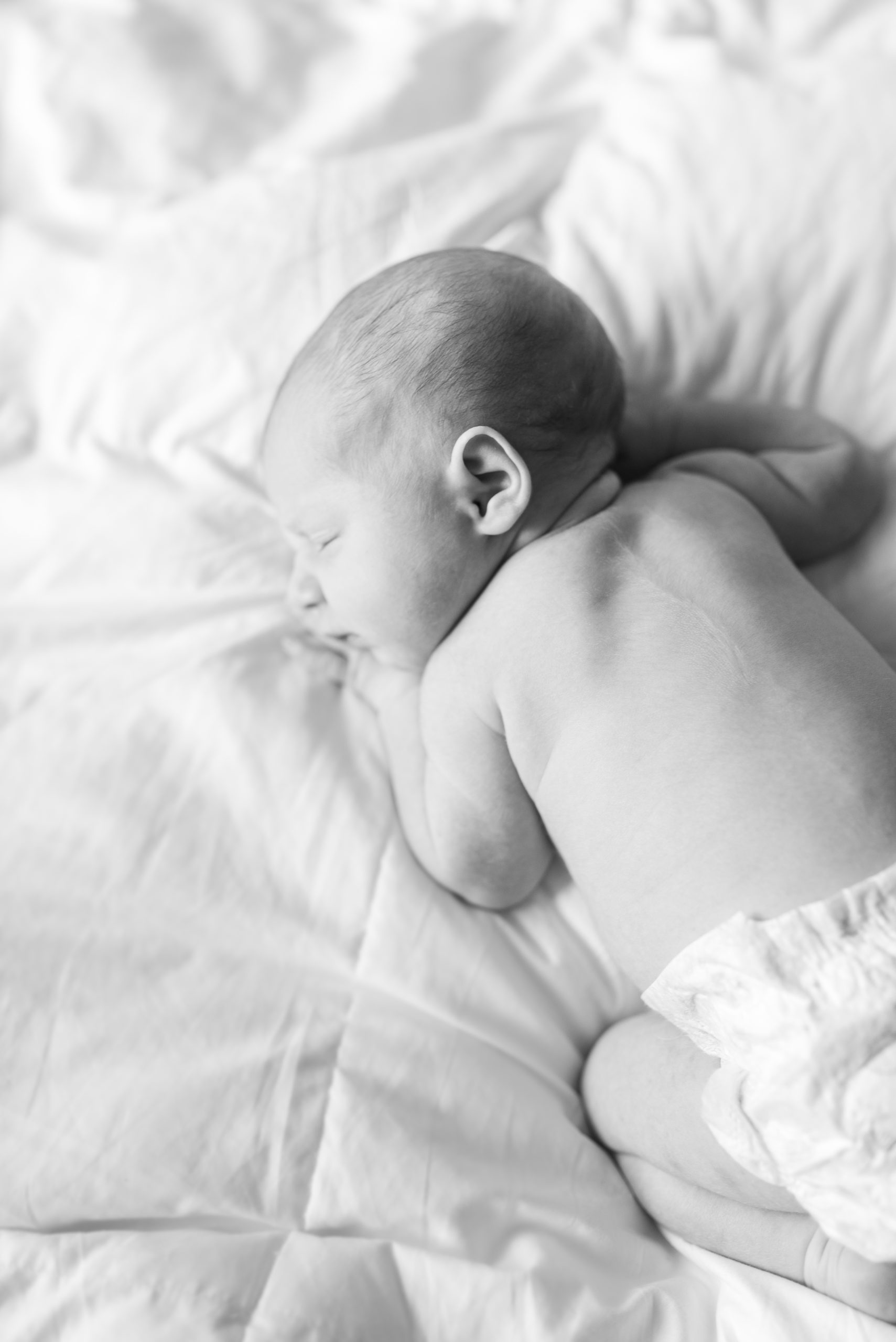 Annessa as a newborn sleeping on the bed