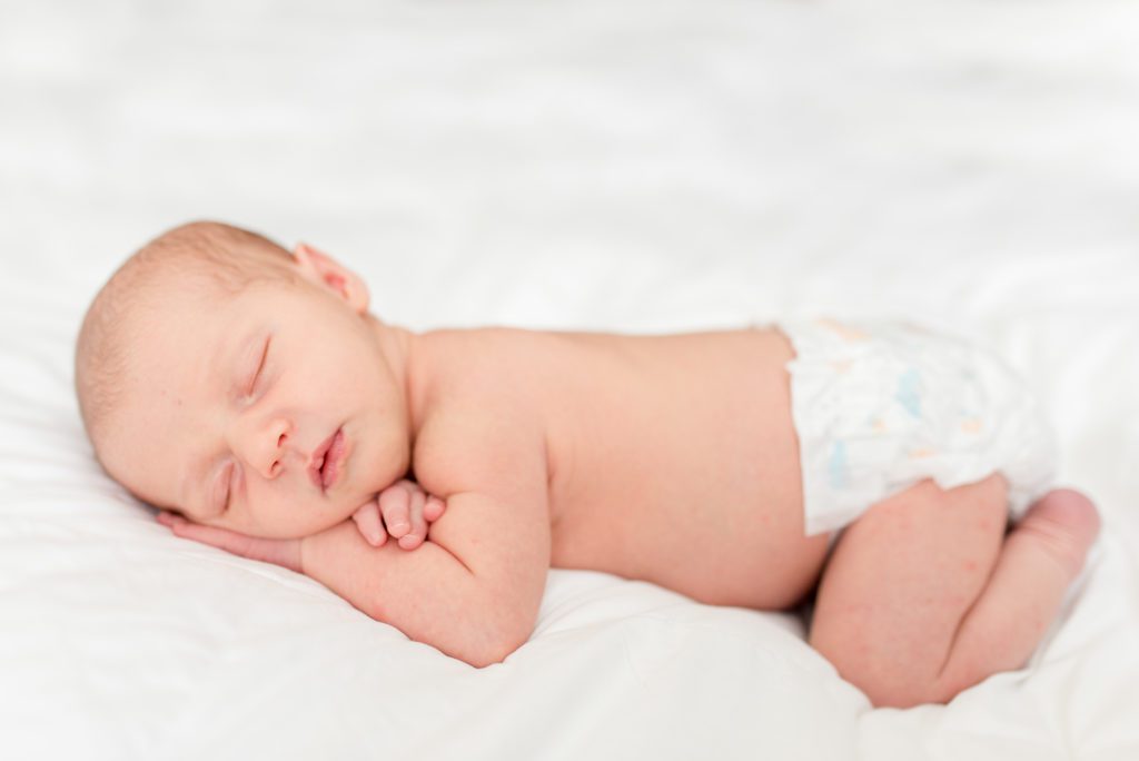 Annessa as a newborn sleeping on the bed