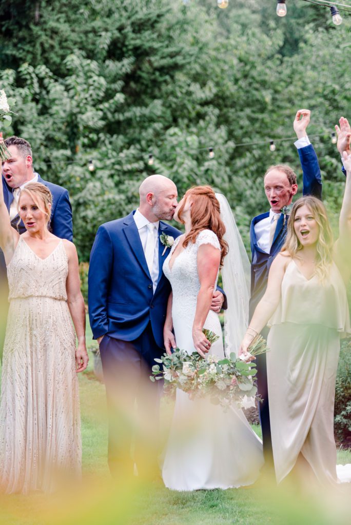 Bride and groom kissing during bridal party photos