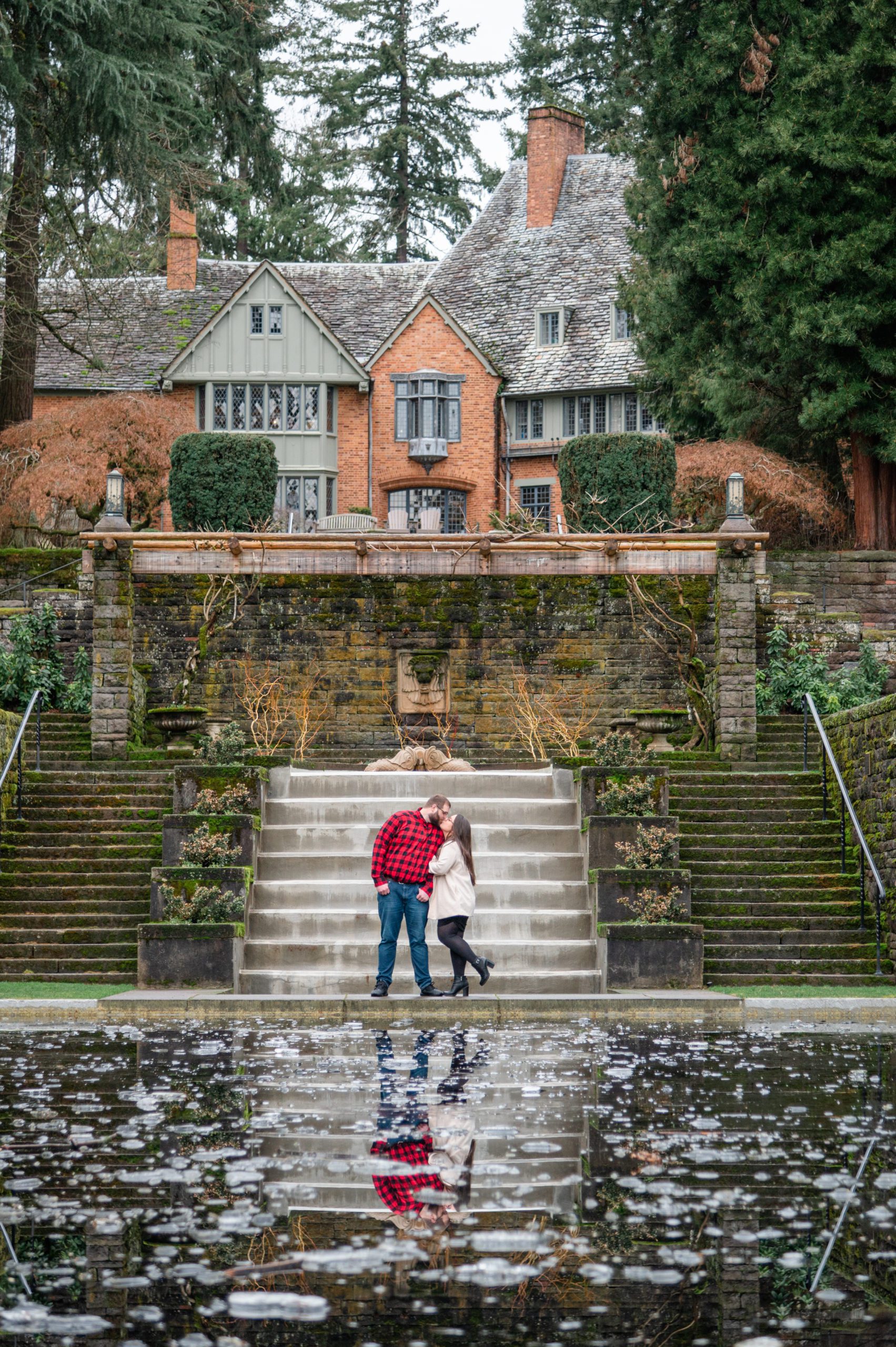 Engaged couple at the reflecting pool at Lewis and Clark College