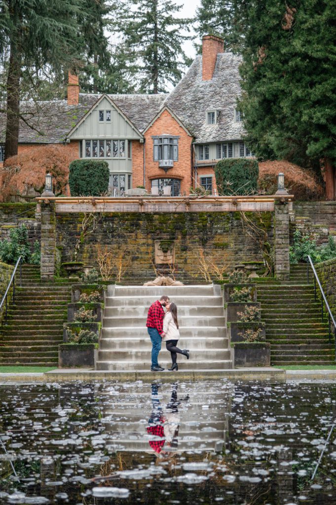 Engaged couple in front of the reflecting pool at Lewis and Clark College