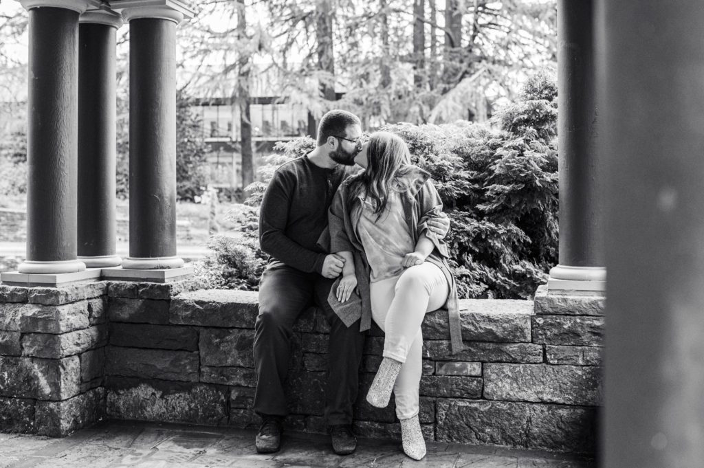 Engaged couple kissing in alcove