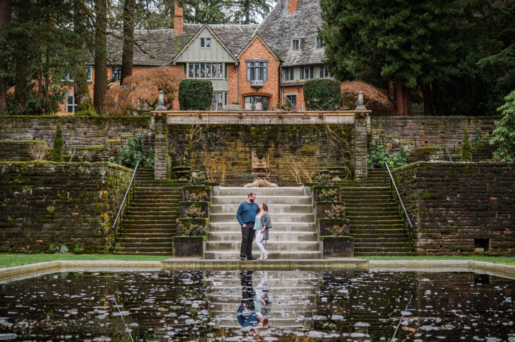 Engaged couple at reflecting pool at Lewis and Clark College