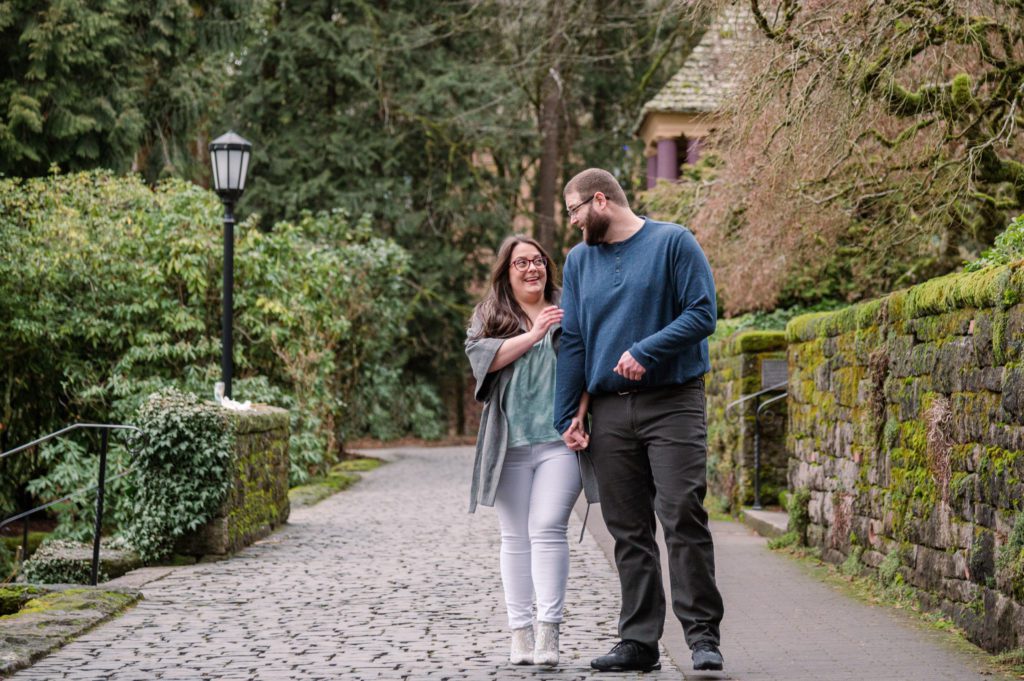 Engaged couple holding hands and laughing