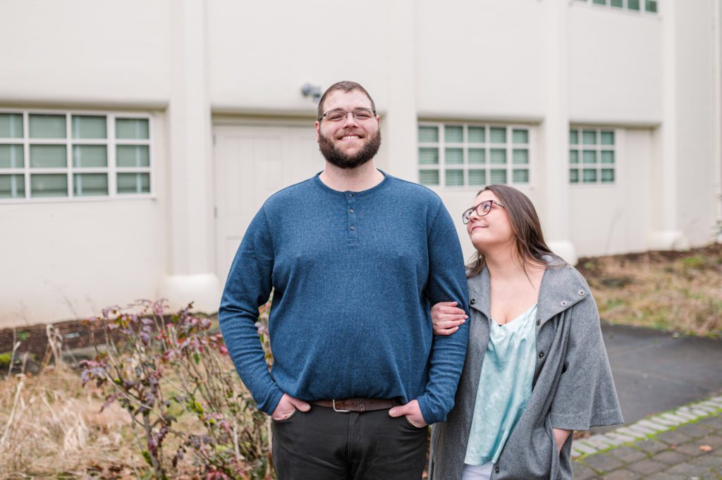 Engaged couple locking arms