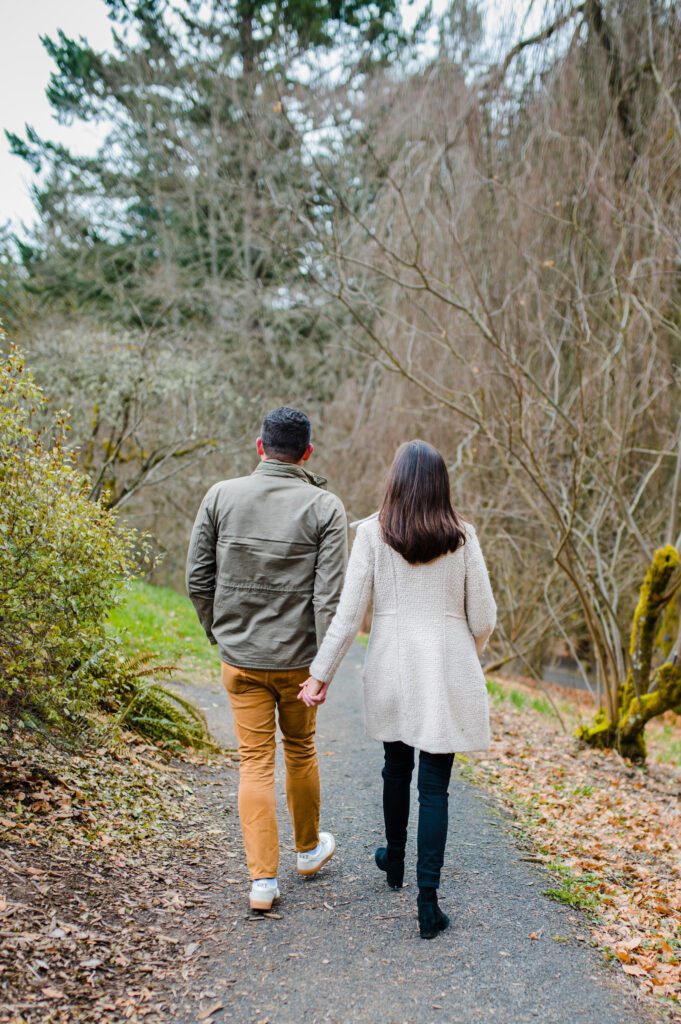 Engaged couple walking away down path