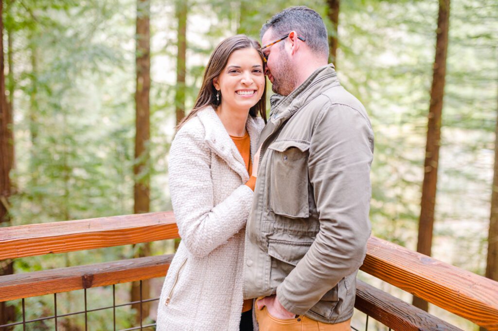 Engaged couple on deck in woods