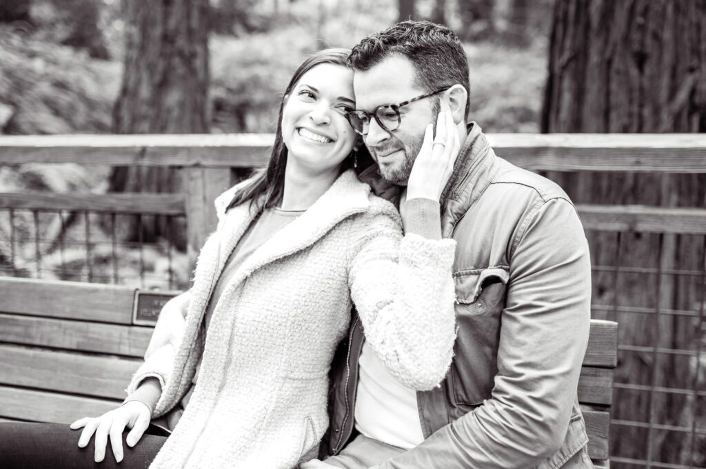 Engaged couple sitting on bench