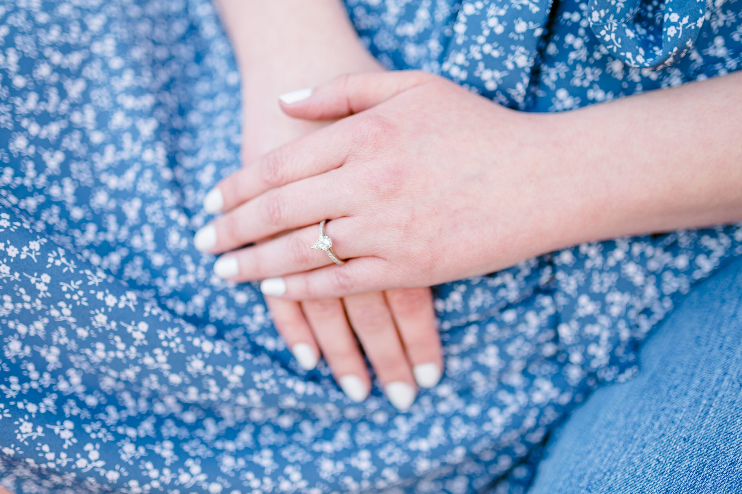Brides hands on her blue polkadot dress with an engagement ring for her photos at the university of oregon in eugene, or