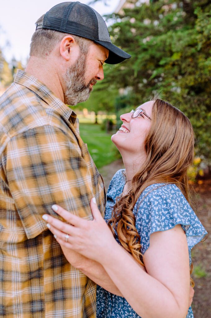 Engaged couple smiling at each other