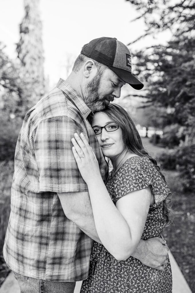 Engaged bride leaning on fiances chest