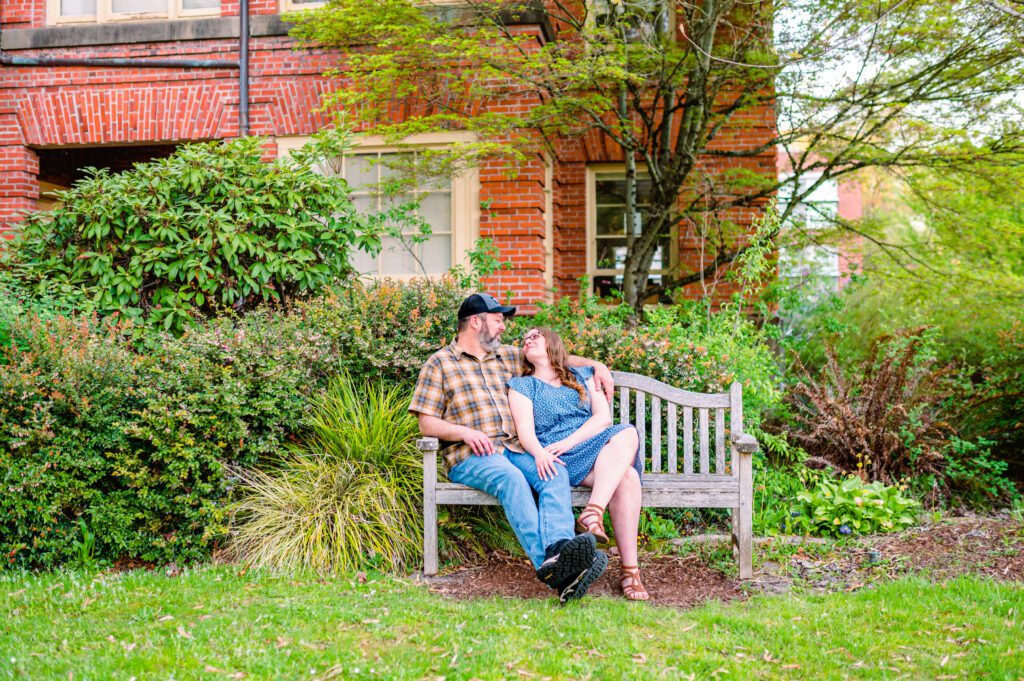 Engaged couple sitting on bench together