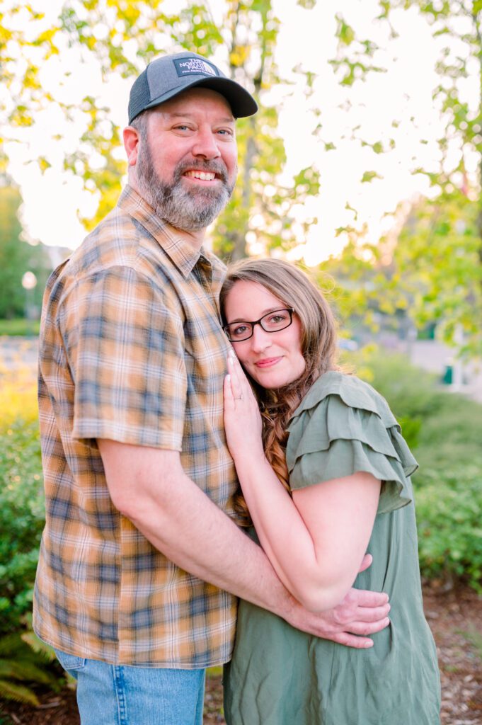 Bride to be leaning on grooms chest