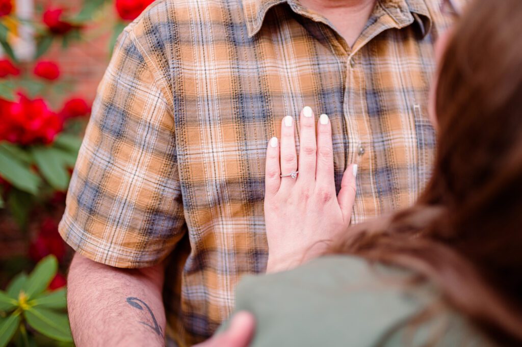 Engagement ring on grooms chest