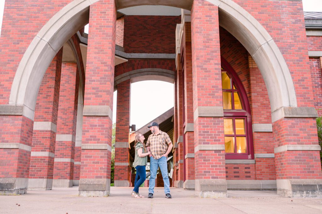 Engaged couple under arch