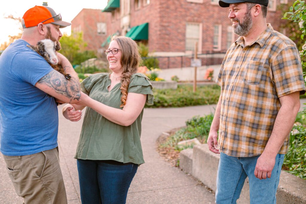 Bride to be taking sheep from stranger for photo