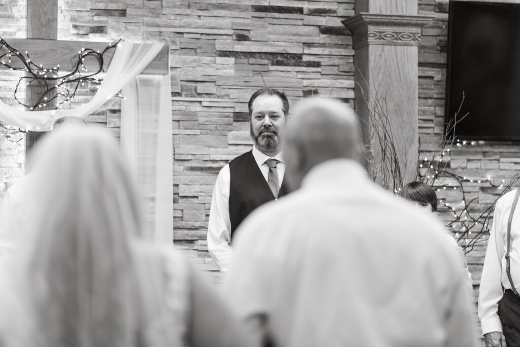 Bride and her father walking down the aisle to her soon to be husband