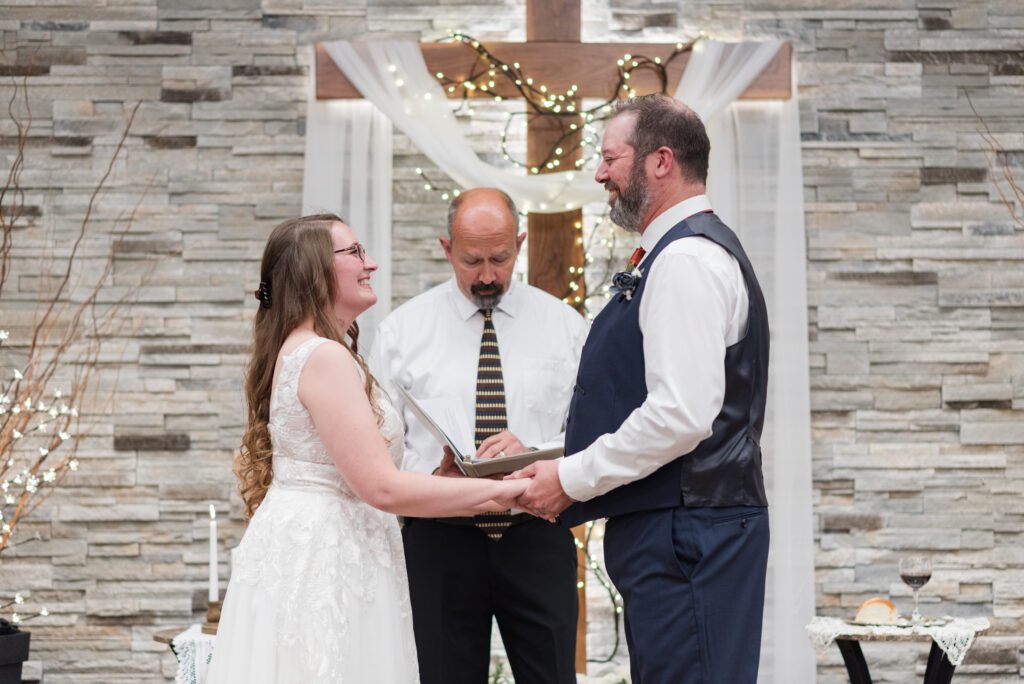 Bride and groom holding hands as they are getting married in Oregon