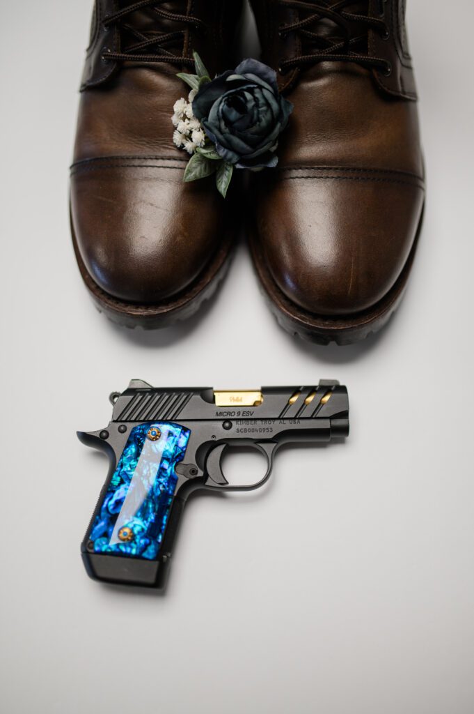 Groom details of his shoes, boutonniere and his gun