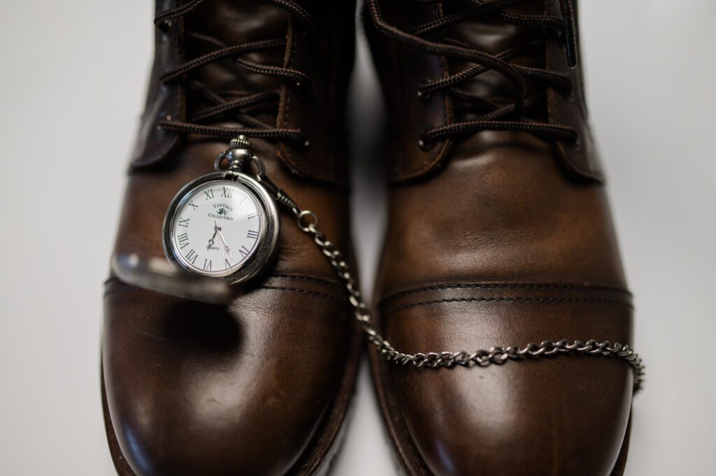 Groom details of shoes and his pocket watch