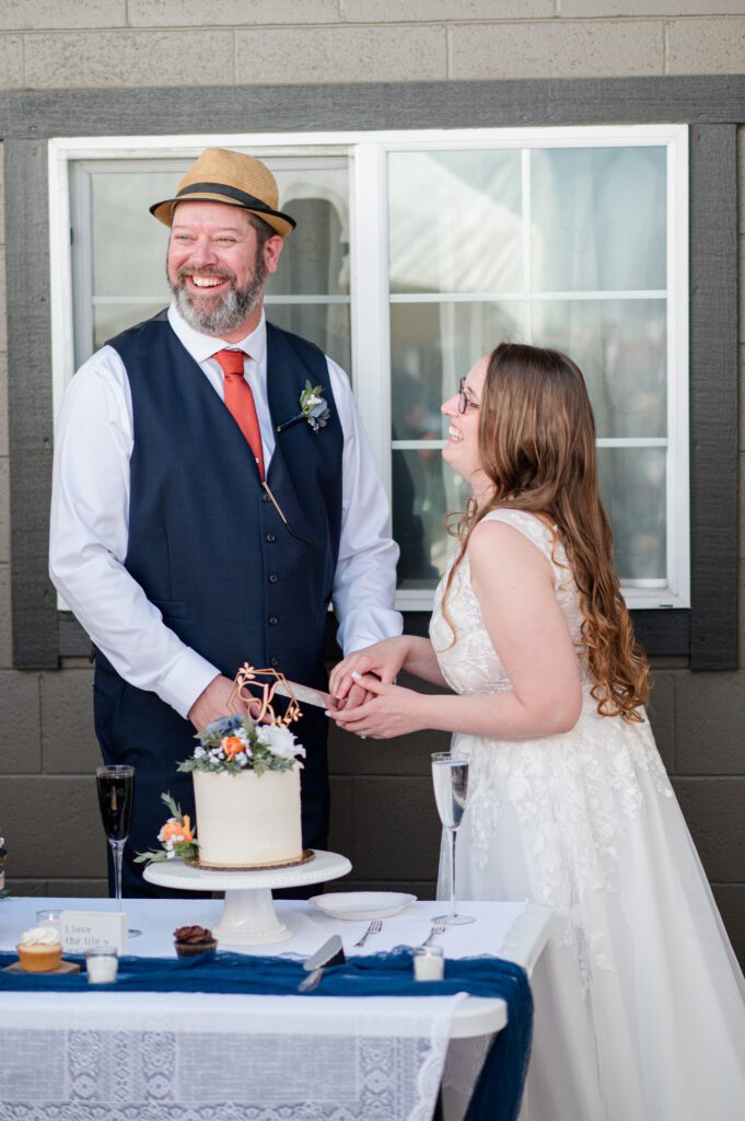 Bride and groom cutting their cake at their wedding in oregon