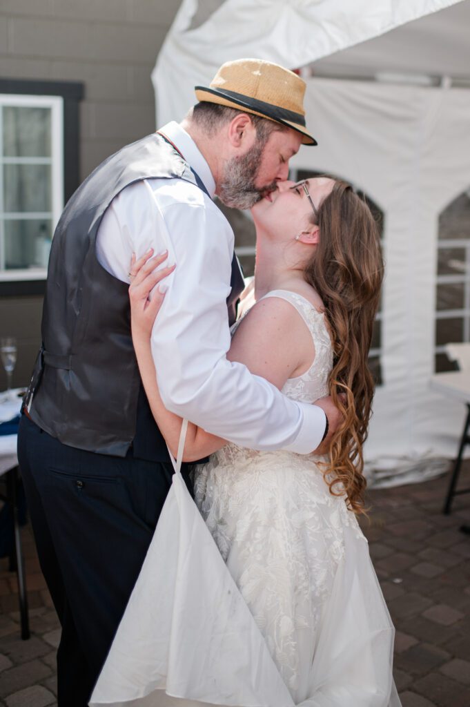 Bride and groom first dance and sharing a kiss