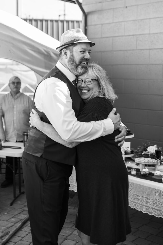 Groom hugging his mother after he just got married