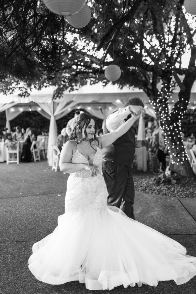 Groom twirling bride during their first dance at East Fork Country Estate in Damascus Oregon