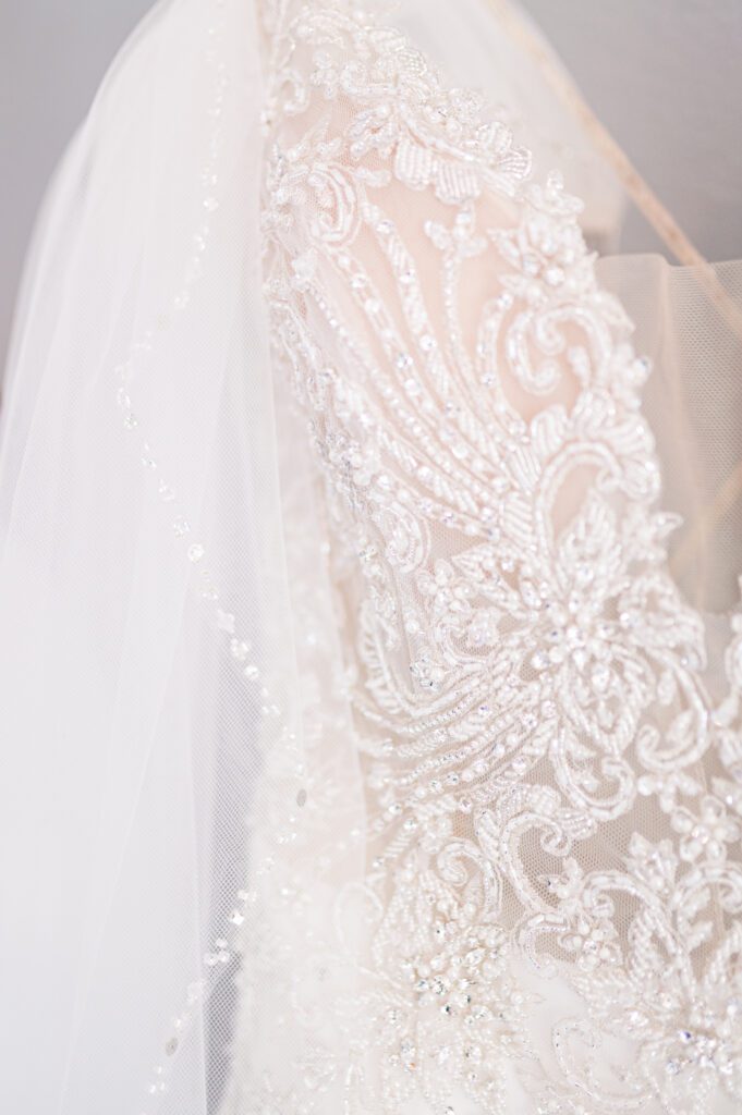 Close up of the brides wedding dress and beaded veil at East Fork Country Estate in Damascus Oregon