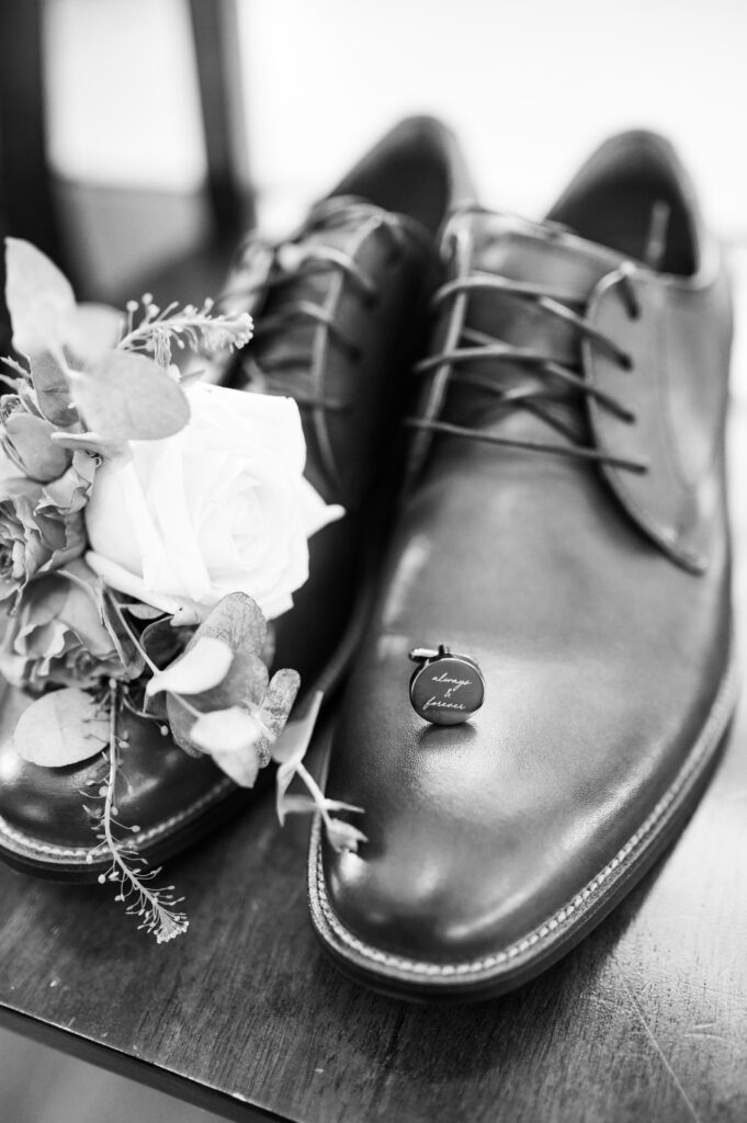 Grooms shoes with his boutonniere and cuff links at East Fork Country Estate in Damascus Oregon