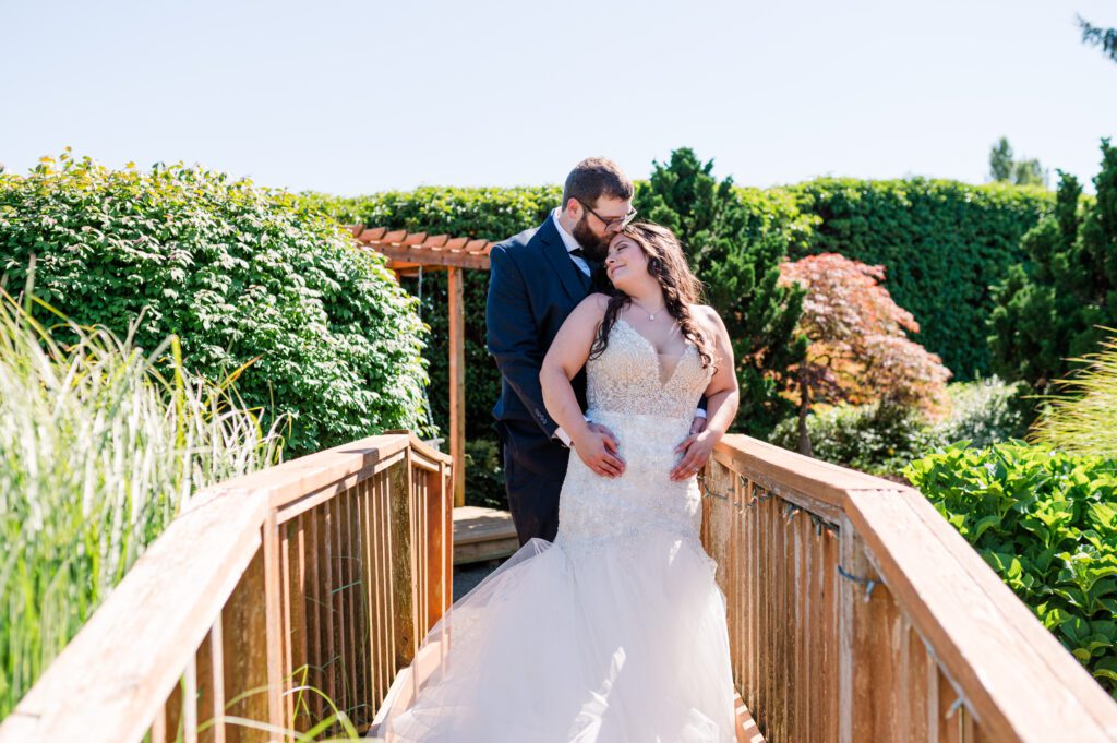 Bride and groom on a bridge after their first look at their wedding venue: East Fork Country Estate in Damascus Oregon