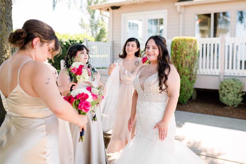 Bride standing with her pink, champagne, and white bridal party before her ceremony at East Fork Country Estate in Damascus Oregon