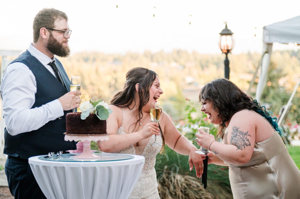 Bride and sister laugh as the sister toasts the new couple at their wedding reception at East Fork Country Estate in Damascus Oregon