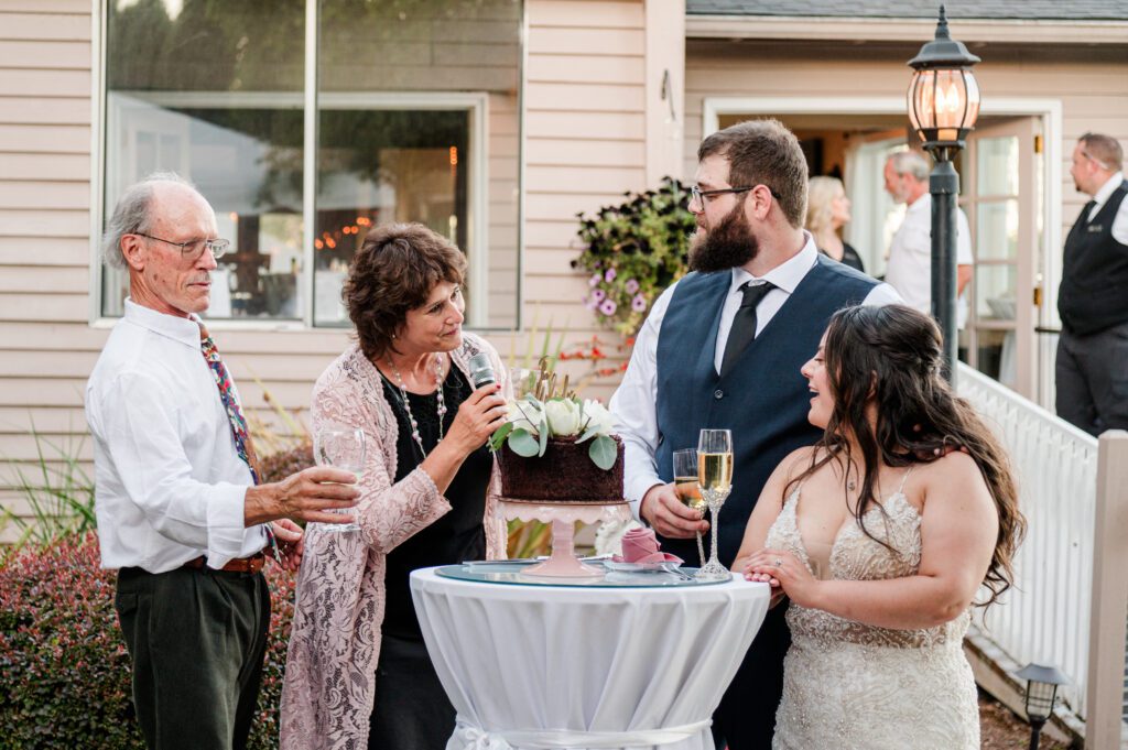 Parents of the groom share a toast with the new couple at their wedding reception at East Fork Country Estate in Damascus Oregon