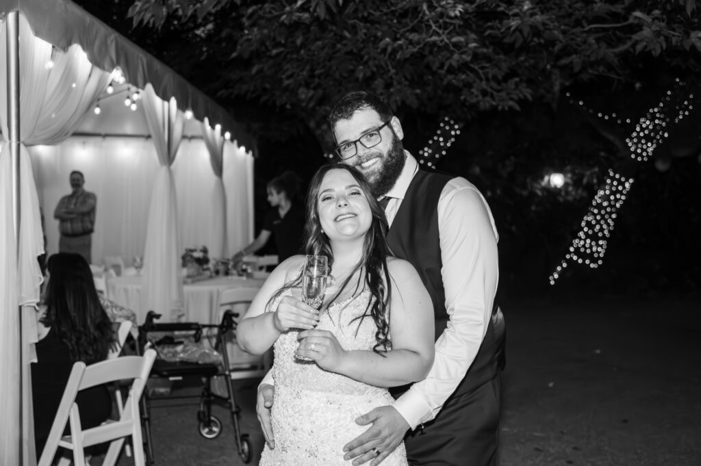 Groom hugging bride at the end of their reception at East Fork Country Estate in Damascus Oregon