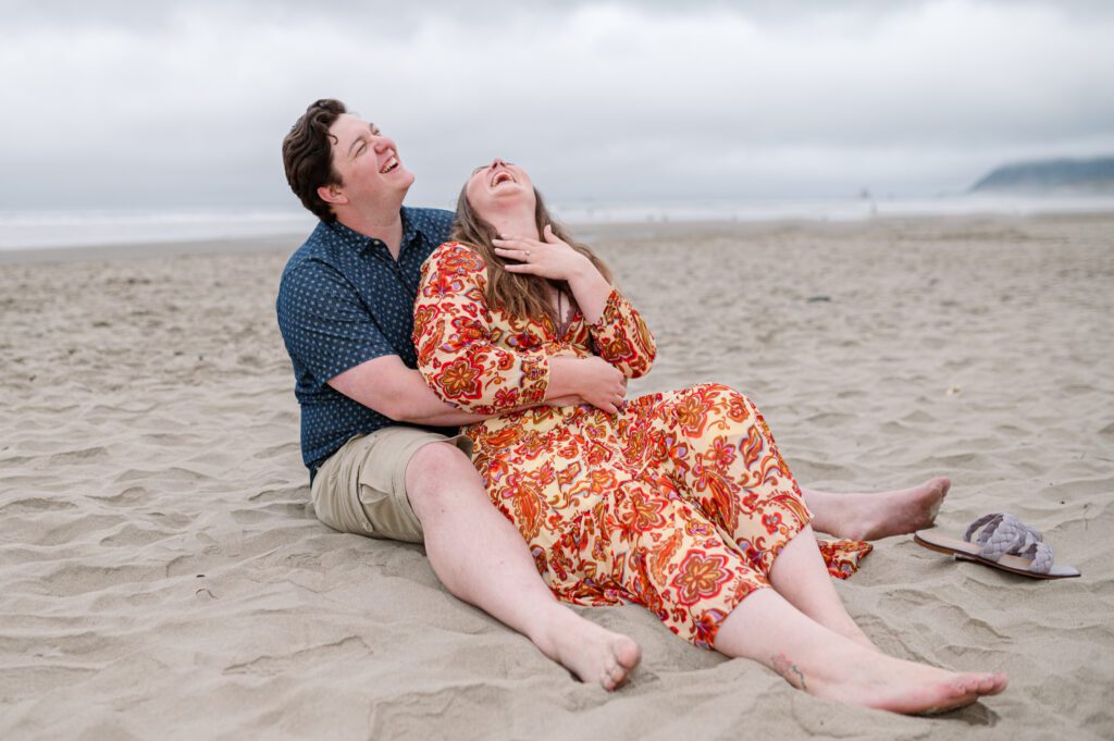 Engagement session where couple is laughing at Cannon Beach in Oregon