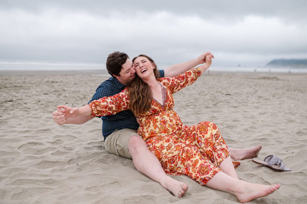 Couple holding hands at their engagement session at Cannon Beach in Oregon